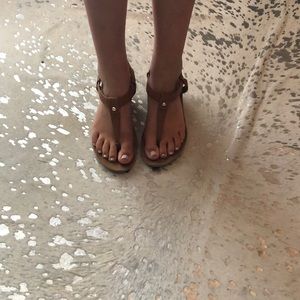 Stylish tan sandals with a heel and straps